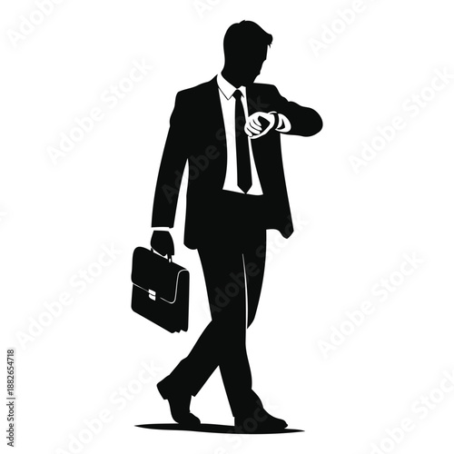 silhouette of a businessman holding a briefcase and checking his watch while walking