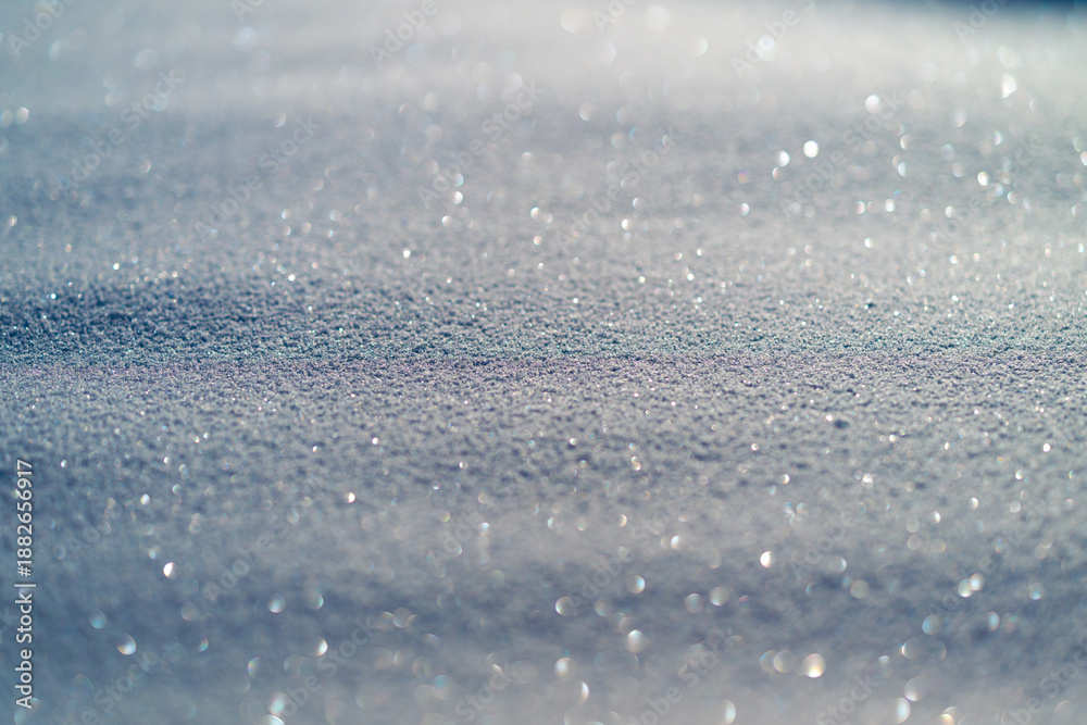 Obraz premium Macro snow crystal texture under sunlight, tiny reflective facets forming glittering field, scientific study mood suitable for research, education, or stock science imagery