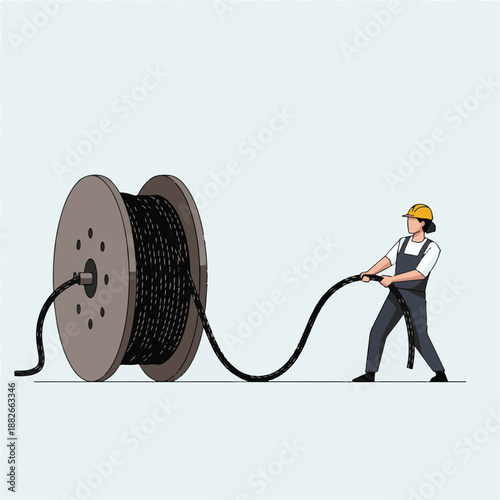 Man pulling large spool of cable.