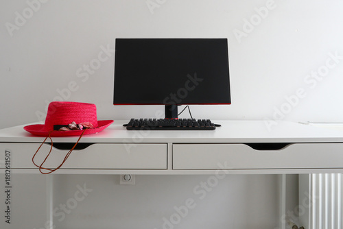 pink hat on the computer desk