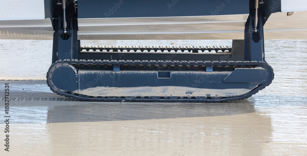 Obraz premium A boat on tracks moves along the beach