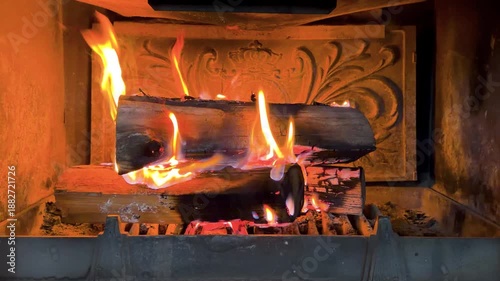 Hot fireplace full of wood. Real Flames from burning logs. Fireplace background. Fire flame close up. Fire background
