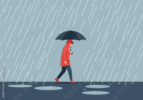 Person walks under umbrella in heavy rain with puddles on ground.