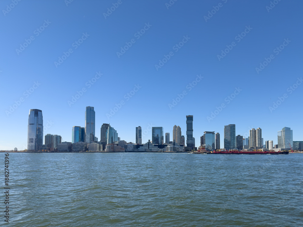 Fototapeta premium Jersey City Waterfront Skyline with Modern High-Rise Buildings on a Clear Day