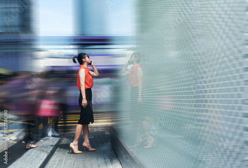 Woman using phone and walking on the street