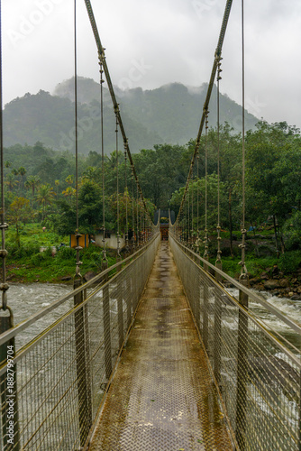 Bridge over a river with a foggy sky in the background