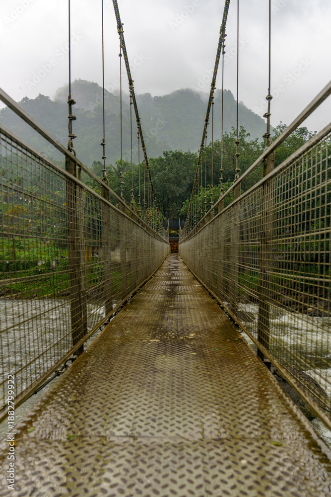 Obraz premium Bridge with a metal railing and a view of a river