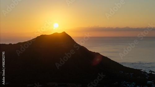 Slika na platnu Golden sunrise over coastal mountain silhouette with calm ocean horizon, warm mo