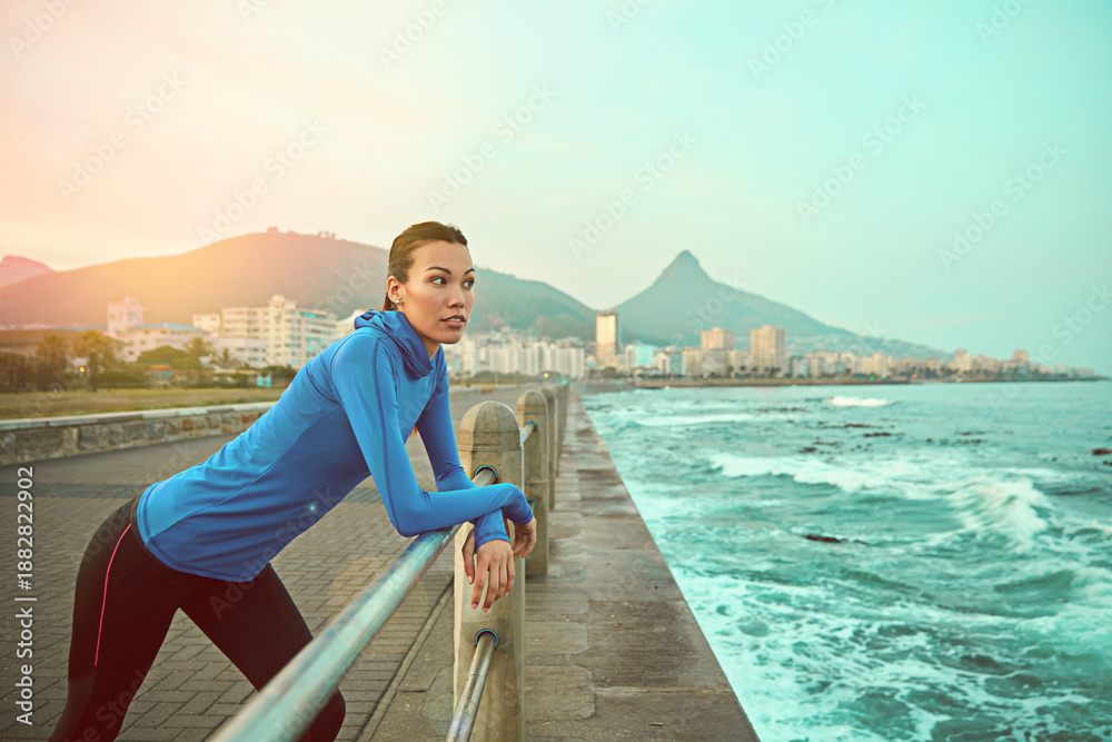 Fototapeta premium Fitness, thinking and woman by sea for rest, break and recovery for cardio workout. Space, sports and person on promenade for exercise, training and active hobby for wellness, health and fresh air