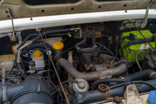 Tableau sur toile The engine of a vehicle is open and the hood is up