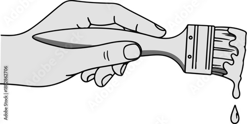 Hand holding a paintbrush with paint dripping from bristles