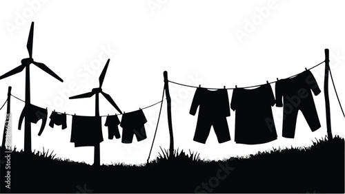 Silhouette of clothes drying on a line with wind turbines in the background