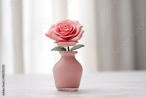 Pink or Red Rose in Small Glass Jar on Neutral Surface with Soft Daylight