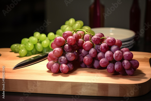 Ripe Grape Cluster Hanging from Vine with Green Leaves Outdoors