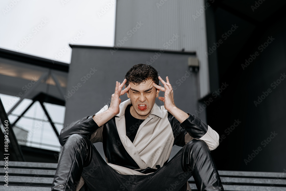 Obraz premium Frustrated young caucasian male expressing anger outdoors in urban setting