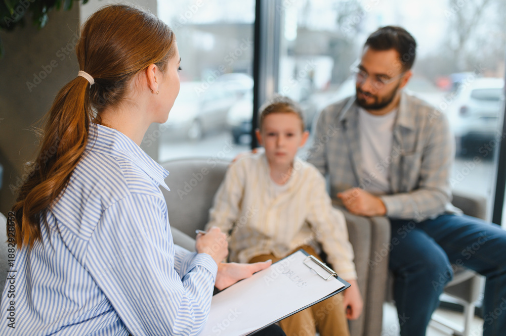 Fototapeta premium Psychologist counseling father and son during family therapy session
