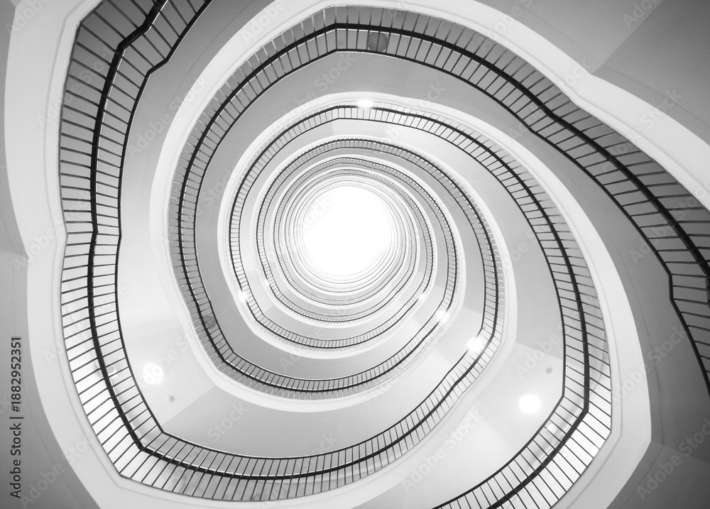 Fototapeta premium Towards the light, staircase black and white shot.