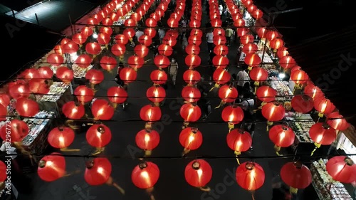 Rows Of Red Chinese Lanterns Illuminate A Night Market With Soft Glow And Bokeh Effect