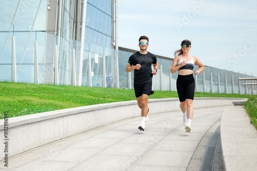Fotografi Couple jogging runners people on track near modern building