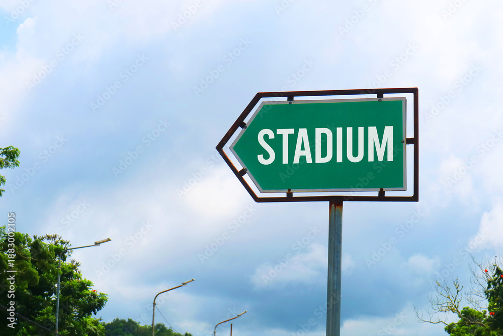 Obraz premium Stadium Road Sign with Dramatic Clouds and Sky.