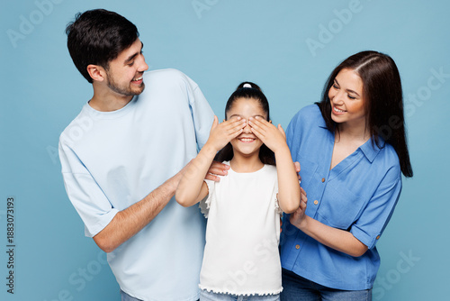 Fotografija Young parent mom dad with child kid daughter girl wear casual clothes close eyes with hands play guess who or hide and seek isolated on plain blue background