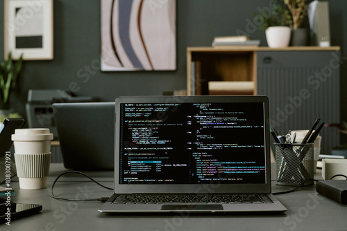 Tableau sur toile Laptop displaying programming code on screen positioned on office desk with take