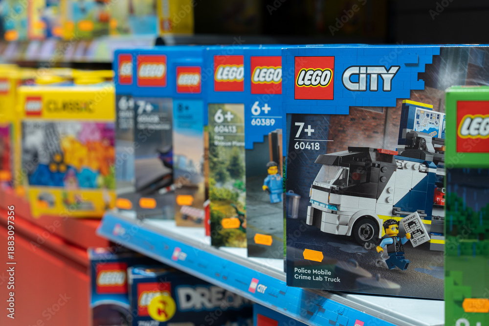 Fototapeta premium Lego products on a shelf in a shop. A close-up of the Lego logo on a box. Various LEGO boxes are neatly arranged on store shelves, ready for purchase. Minsk, Belarus - March 4, 2025