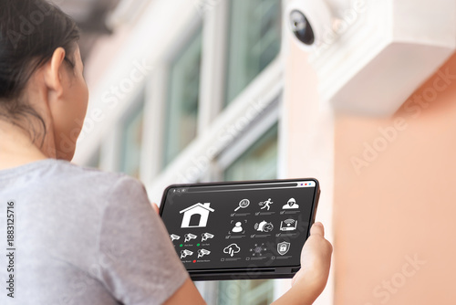 Smart Home Security System with AI Technology Concept, Asian Woman Using Tablet to Manage IP Camera, Network Connection, Motion Detection, Cloud Data Storage and Anti-Theft Protection, Cybersecurity