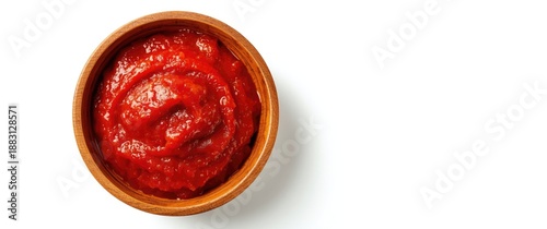 Top view of a wooden bowl containing tasty tomato paste isolated on white