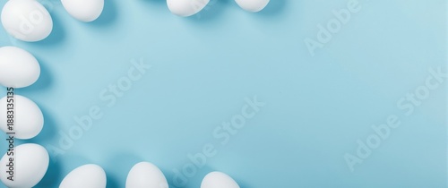 Spring Easter holiday background with white Easter eggs and room for text on a blue backdrop, ideal for gift and celebration themes