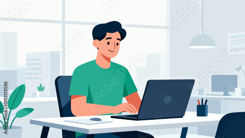 A man is sitting at a desk with a laptop in front of him. He is smiling and he is enjoying his work. The room is well-lit and has a modern, clean look. The man is wearing a green shirt and jeans