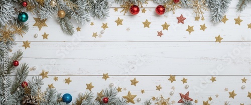 Festive Christmas or New Year background featuring fur-tree branches, colorful glass balls, and shining stars on white wooden background, top view, copy space