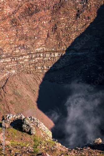 Mount Vesuvius volcano crater showing rocky terrain with active fumaroles releasing steam in Italy
