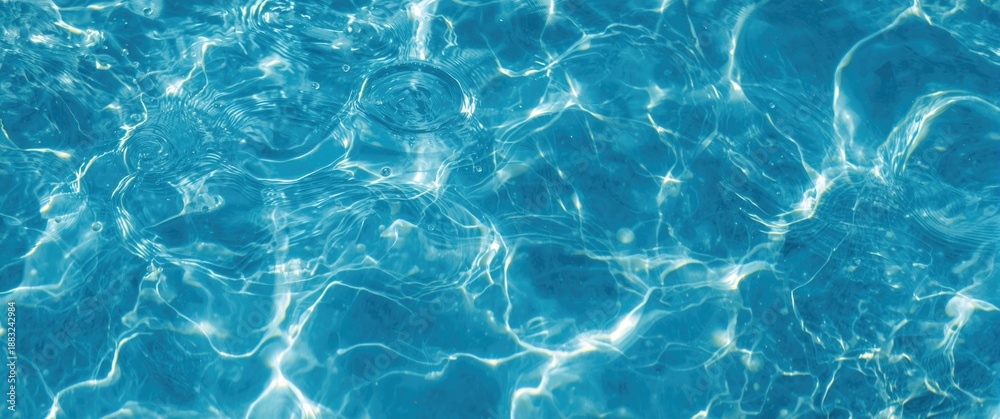Obraz premium An enchanting display of clear blue water dancing with ripples, splashes, and bubbles, creating an abstract water wave scene lit by sunlight