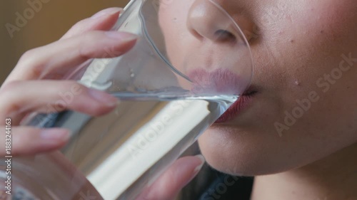 Close up female woman Asian Korean lips unrecognizable girl drinking clean water at home feeling thirsty morning hydration ritual holding glass healthy habit refreshment dehydration lifestyle drink