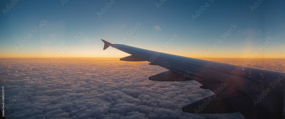 Obraz premium Passenger perspective of the sky and Earth beyond the airplane window with wing in sight