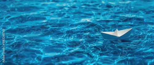 Paper boat sailing on a blu...