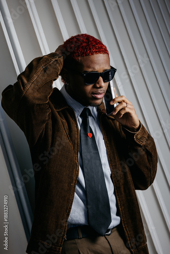 Black man talking on the phone worried