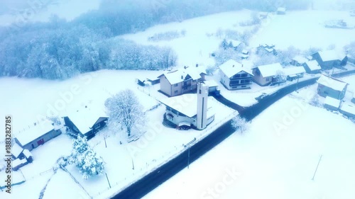 Snowy village church aerial view