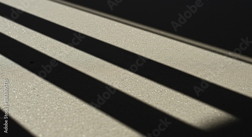 High contrast abstract composition showing sharp geometric shadows crossing a textured surface under bright, natural sunlight ,facade ,architecture ,dark