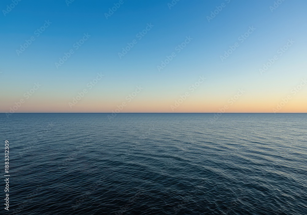 Obraz premium A beautiful wide open view of the expansive horizon line separating the clear blue sky above and the calm water below at sunset time ,wide ,sunrise ,sky