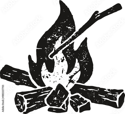 Campfire with flames and marshmallow roasting on stick over logs and charcoal