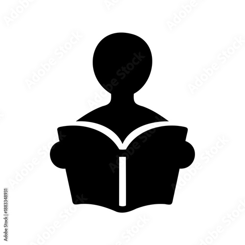 Silhouette of a person reading an open book, focus and learning