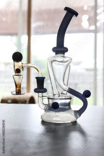 Фотография Modern Glass Dab Rig Water Pipe With Blue Accents on Tabletop Indoors for Smokin