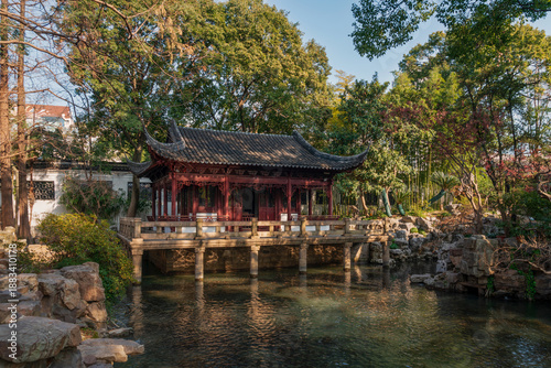 The Nine Lion Study Pavilion on the shore of the pond in the Yuyuan Garden (Yu Garden) on a sunny day, Shanghai, China