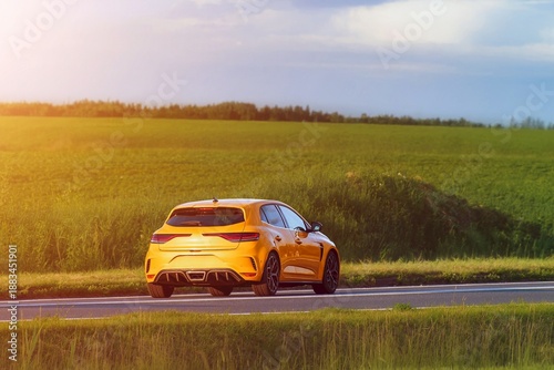 Photography Hatchback driving along asphalt road in countryside