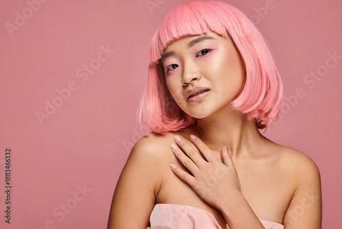 Bild auf Leinwand Young woman embraces beauty in vibrant pink attire against a soft pastel backdro