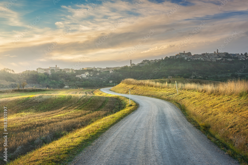 Fototapeta premium Country Road at Dawn with Montepulciano Skyline and Vineyards