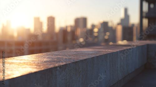Urban rooftop scene w/ concrete ledge & blurred skyline in the distance, golden hour light