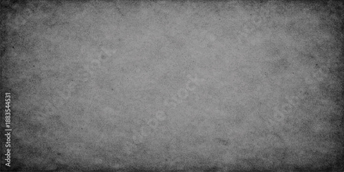 Aged vintage wallpaper design featuring a dark grey grunge paper texture on a rough dirty concrete stone surface backdrop